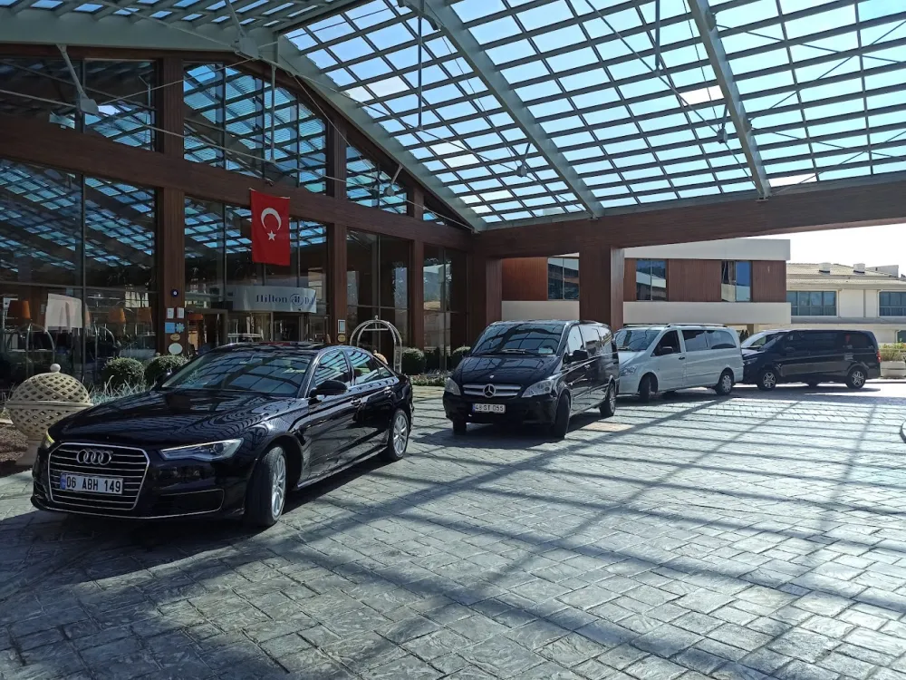  Luxury transfer vehicles  parked in front of Hilton Dalaman Resort entrance - VIP transportation between air